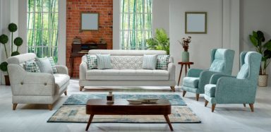 A photo of a living room, showing a couch, blue chairs, and a coffee table.
